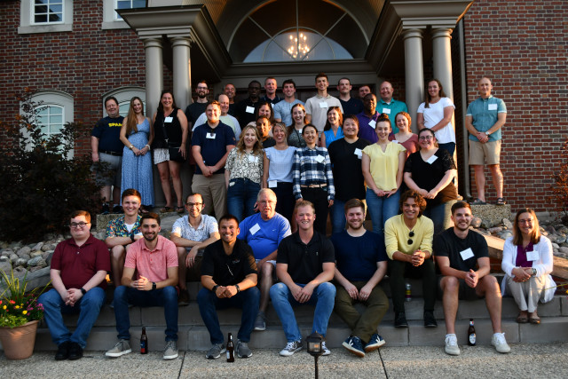 group of staff in front of house